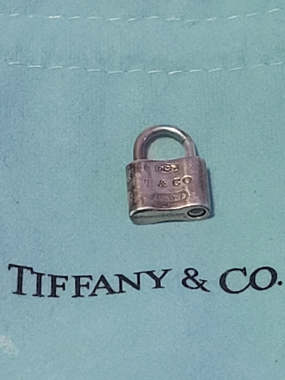 Tiffany & Co. Sterling Silver Padlock Charm on Blue